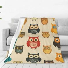 an owl themed throw blanket on a couch