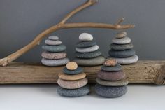 several rocks stacked on top of each other near a branch