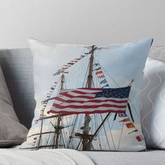 an american flag on the mast of a sailing ship throw pillow