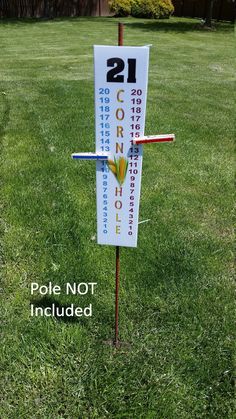 a sign that is in the grass with numbers on it and arrows pointing to different locations