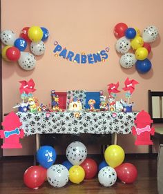 a table with balloons and decorations for a children's birthday party