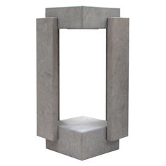 a concrete sculpture sitting on top of a white floor