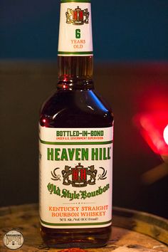 a bottle of beer sitting on top of a barrel