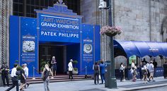 people are walking in front of the grand exhibition at patek philippe