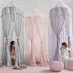 a woman is standing in front of some pink and silver decorations