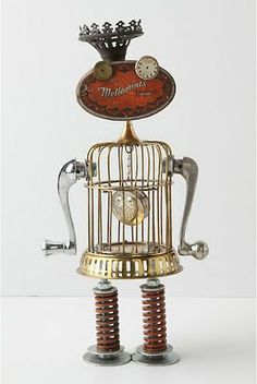 a golden metal robot with a clock in its cage