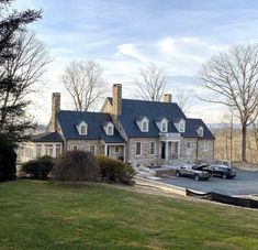 a large house with two cars parked in front of it