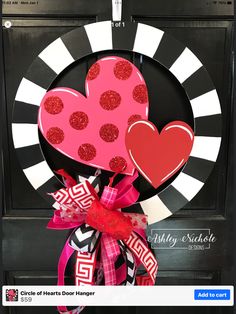 a valentine's day door hanger with two hearts on it