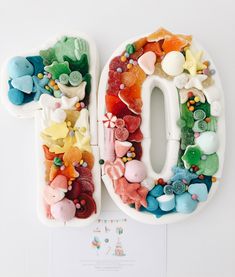 the letter o is made out of plastic and decorated with colorful candies on it