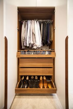 an organized closet with shoes and pants