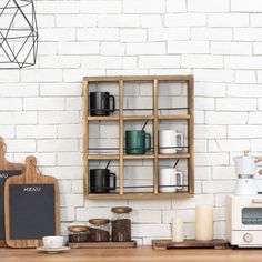 a kitchen with white brick walls and wooden shelves filled with coffee cups, mugs, and other items