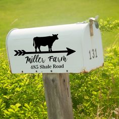 a mailbox with a cow on it and the name miller farm is shown in black