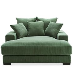 a green couch with some pillows on it