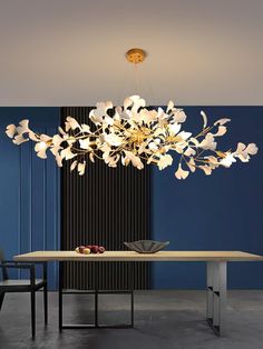 a modern chandelier hanging over a dining room table