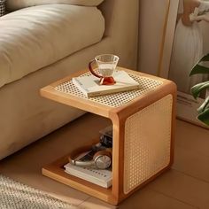 a wooden table with a glass on it next to a couch