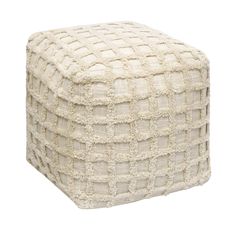 a white poufce ottoman sitting on top of a floor