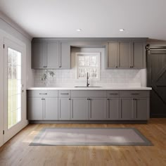 an empty kitchen with gray cabinets and white counter tops is seen in this image from the doorway to the living room