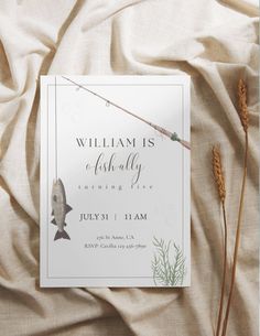 a fishing themed baby shower is displayed on a bed with white sheets and brown reeds