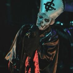 a man wearing a skull mask and holding a microphone