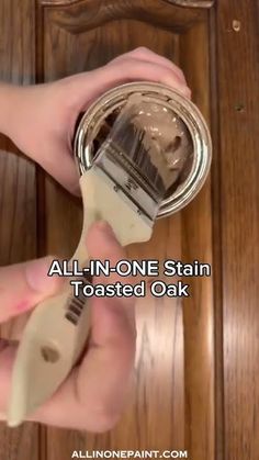 someone is using a paint brush to remove stains from the door knobs on a wooden door