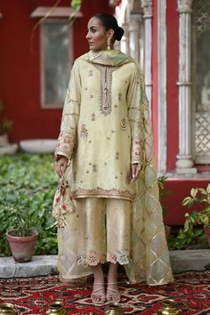 This festive silhouette is cut from cotton net in a refreshing lemon and is detailed with gota and floral embellishments. The look is completed with an organza chatta-pati dupatta with hues of lavender, teal and blush pink with triangular gota finishing and a gold brocade izaar. A piece that is a timeless wardrobe clas Embroidery Suits Design, Pakistani Dress Design, Indian Designer Outfits, Embroidery Suits, Indian Outfit, Desi Fashion, Indian Designer Wear, How To Dye Fabric, Indian Design