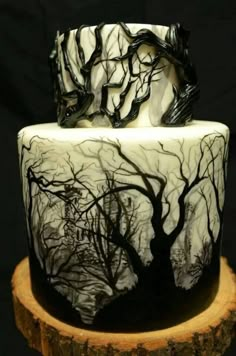 a white and black cake with trees on it