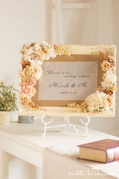 a table with a sign and flowers on it