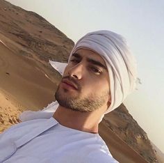 a man wearing a white turban in the desert