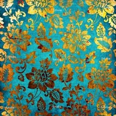 a blue and gold rug with flowers on it