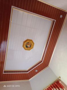 the ceiling in this room is painted red and white with gold trimmings on it