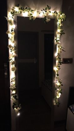 a mirror with lights and flowers on it