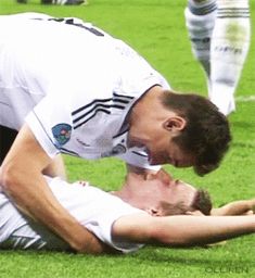 two men are playing soccer on the field