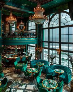 the interior of a restaurant with green chairs and chandeliers on the balcony overlooking the ocean