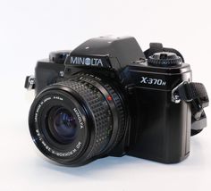 a black camera sitting on top of a white table