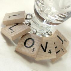 some scrabbles that are sitting on top of a glass bottle with water in it