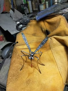 a pair of scissors sitting on top of a yellow glove