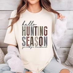 Show off your hunting season pride with this stylish "Hunter's Wife" tee, perfect for those who support their partners' passion for the outdoors. Made for comfort and style, this tee combines a trendy design with a relaxed fit, ideal for cozy days at home or cheering on from the sidelines. With a chic yet rugged look, it's the perfect blend of style and love for the hunt, making it a must-have for any hunter's better half. Great for layering or wearing solo, this tee is a fun way to show off your hunting season spirit in style! Hunters Wife, From The Sidelines, Rugged Look, Hunting Season, Better Half, Girlfriend Gift, Plein Air, The Outdoors, Hunting