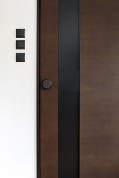 the door is brown and black with three square knobs on each one side,