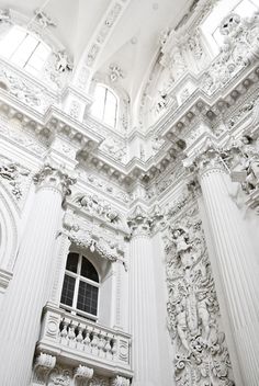 an ornate white building with windows and balconies on the ceiling is shown in black and white