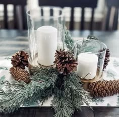 pine cones and candles are arranged on a table