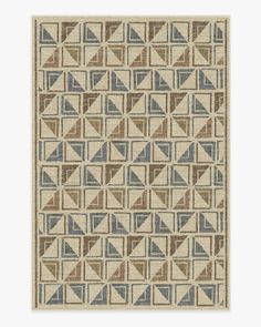 a beige and blue rug with geometric shapes on the bottom, in various shades of brown