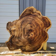 a large piece of wood that has been cut in half and is sitting on the ground