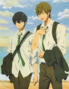 two young men standing next to each other on a beach