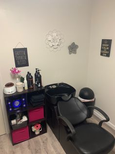 a hair salon with black chairs and various items