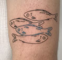 a man's leg with two fish on it and one is drawn in blue ink