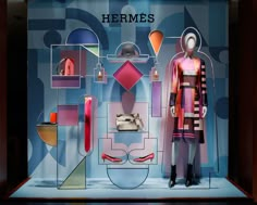 a mannequin in front of a window display with geometric shapes and colors on it