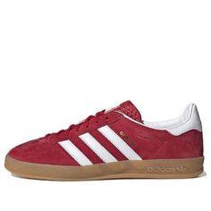 The adidas Gazelle Indoor 'Scarlet Gum' is a modern take on the classic 1979 Gazelle Indoor sneaker. Crafted with a soft suede upper and durable leather lining, the sneaker features a semi-transparent effect and the iconic 3-Stripes and metallic gold lettering for a timeless look. Perfect for any active lifestyle, this sneaker is sure to make a statement. The Gazelle Indoor series is inspired by the classic '79 Gazelle, with a modern twist. The 'Scarlet Gum' colorway is a vibrant red hue that will add a pop of color to any outfit. (SNKR/Skate/Light/Casual/Wear-resistant) Casual Sneakers In University Red With Vulcanized Sole, Casual Sneakers With Vulcanized Sole In University Red, University Red Sneakers With Gum Sole, University Red Sneakers With Vulcanized Sole, Casual University Red Sneakers With Gum Sole, Adidas Suede Sneakers With Round Toe, Classic University Red Sneakers With Rubber Sole, Casual Adidas Logo Suede Skate Shoes, University Red Leather Skate Shoes With Rubber Sole