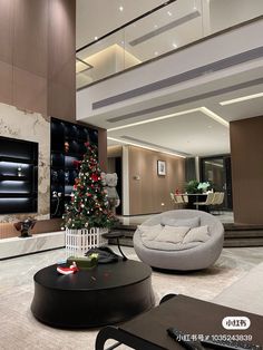 a living room filled with furniture and a christmas tree in the middle of the room