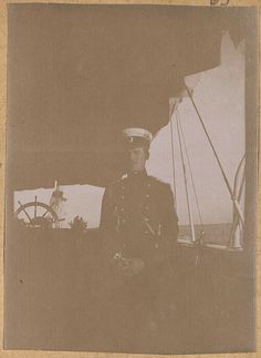 an old photo of a man in uniform on a boat