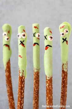 four sticks with faces painted on them